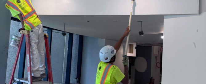 How to Choose the Right Coating System for Your Project - Crew painting the interior of a building.