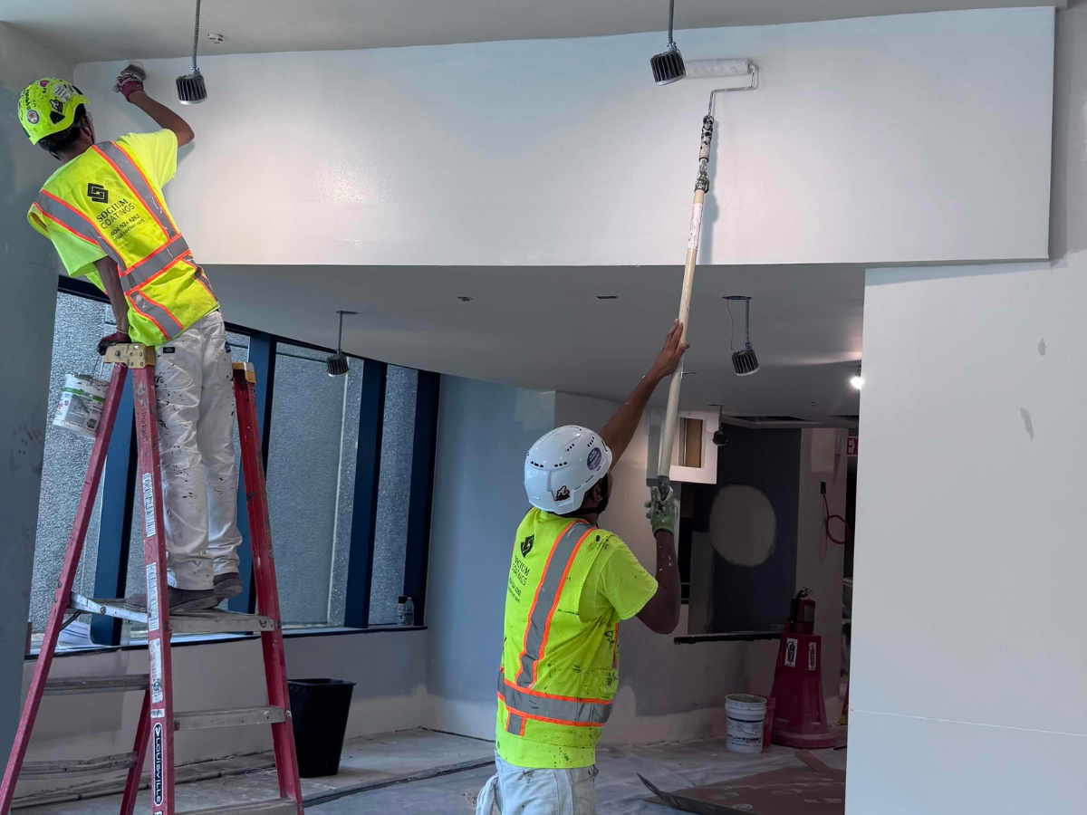 How to Choose the Right Coating System for Your Project - Crew painting the interior of a building.