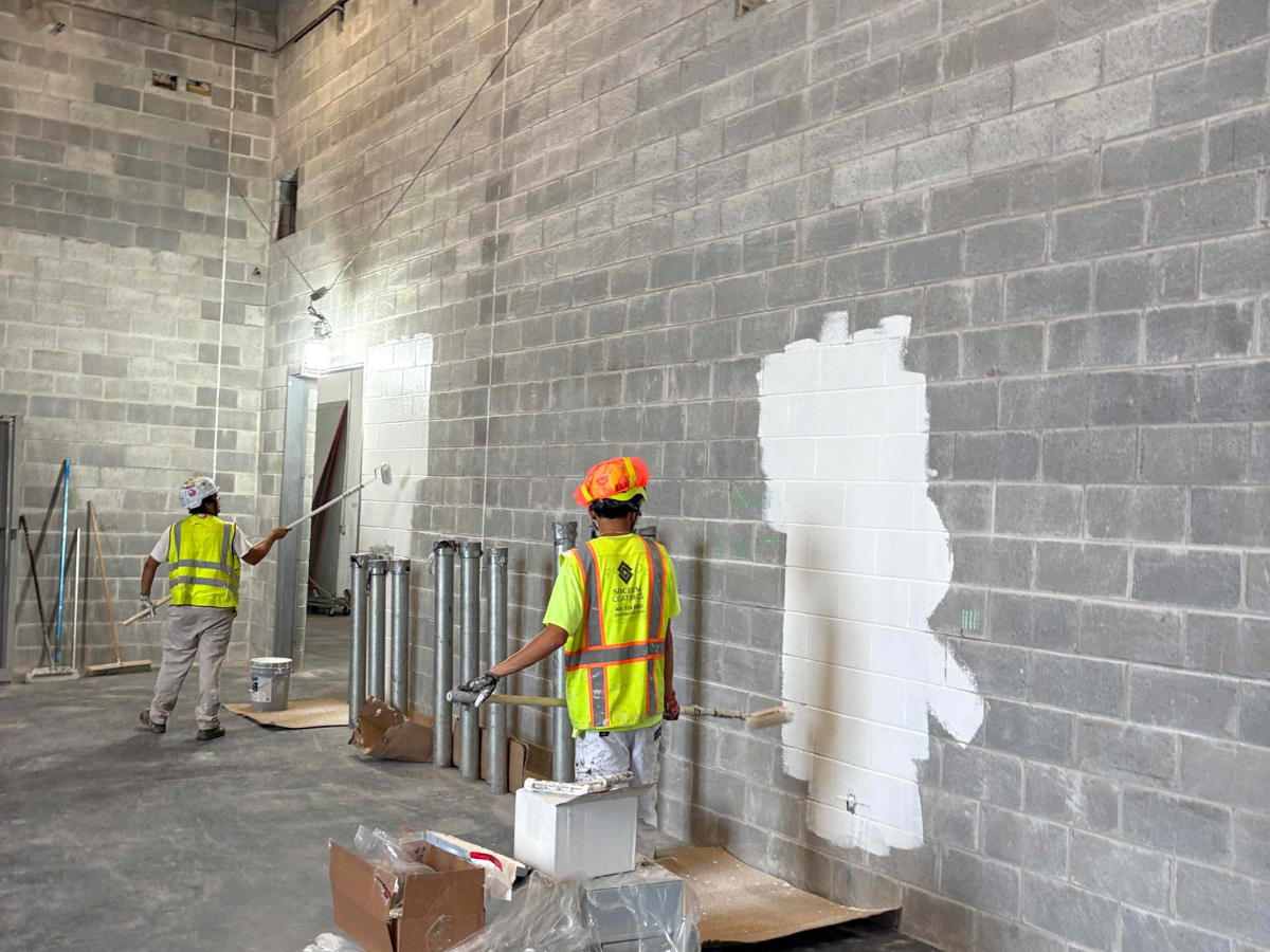 What It Means to Be a Certified Minority Business Enterprise (MBE) - our team painting a facility