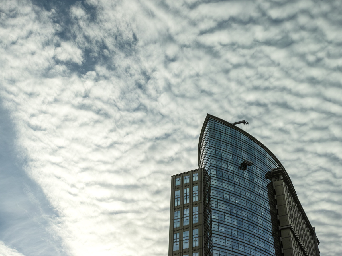 The Impact of Weather Extremes on Coatings Performance in Georgia — and Strategies to Mitigate Degradation - Skycraper with cloudy sky above it