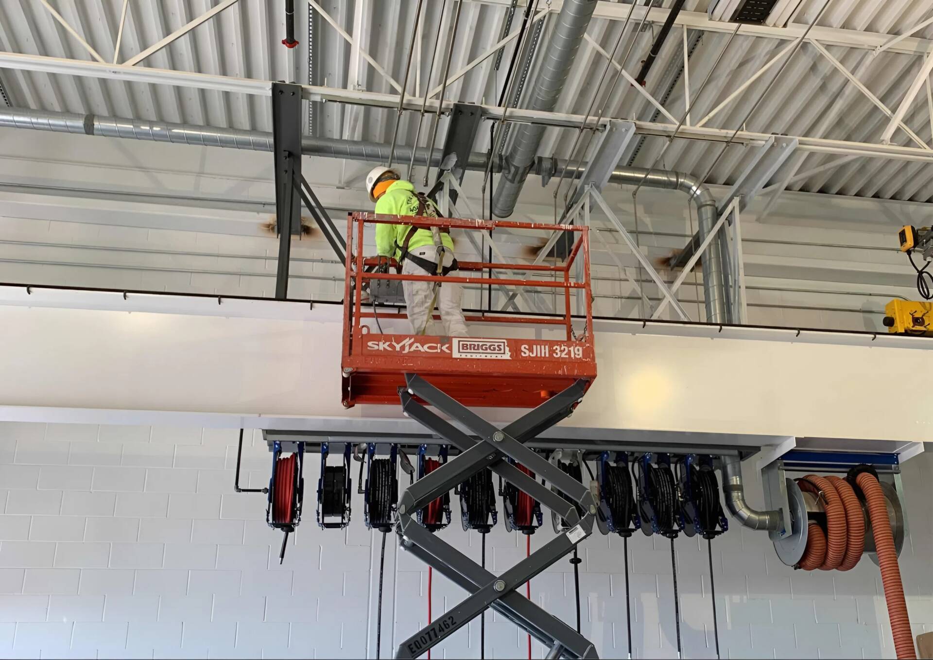 Aviation painter applying protective coatings using lift equipment