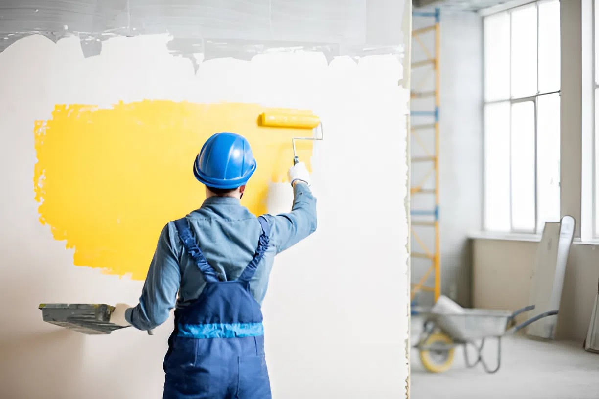 Professional painter applying paint with a roller