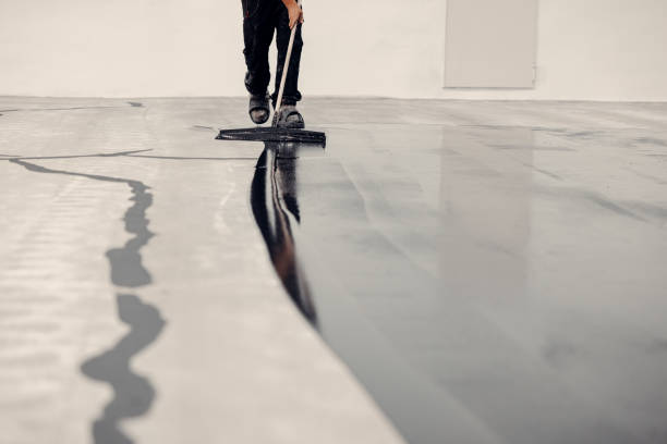 Industrial floor coatings being applied by a professional