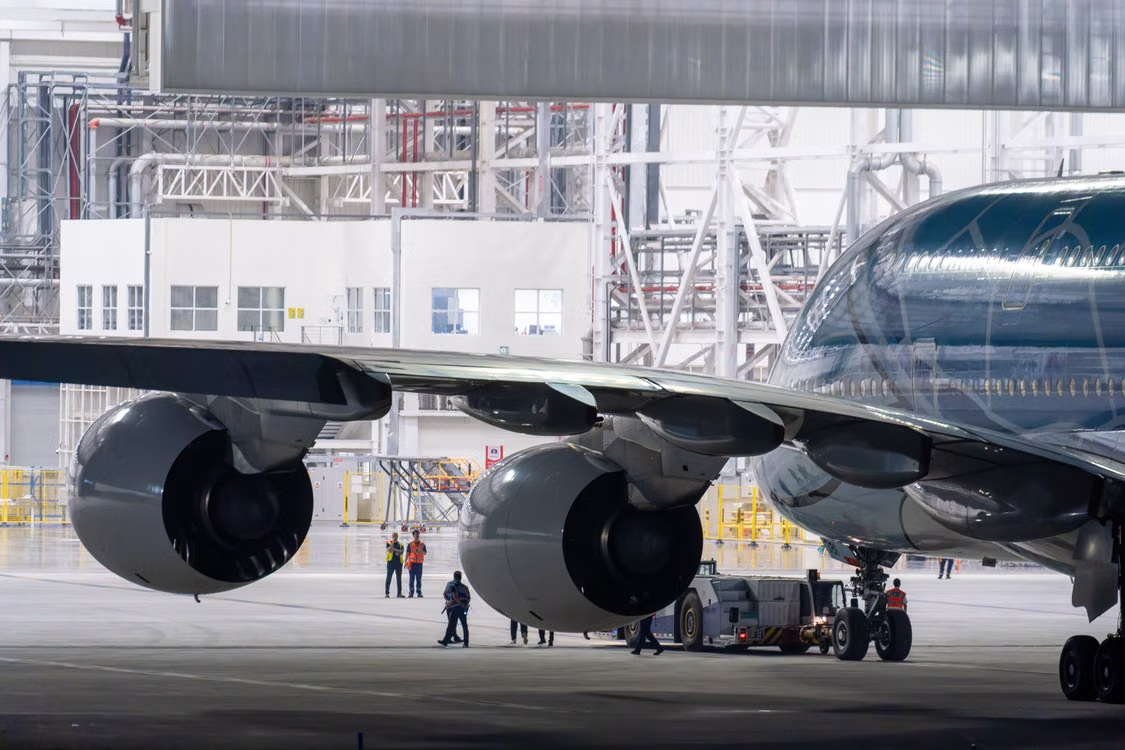 Airport hangar under maintenance with working professionals