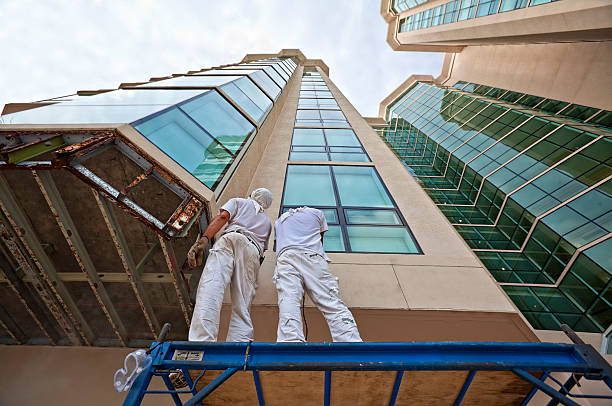 Professionals working on a commercial building painting project
