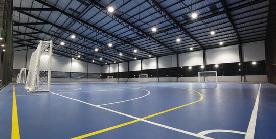 Spacious indoor sports facility with professionally painted walls and high ceilings