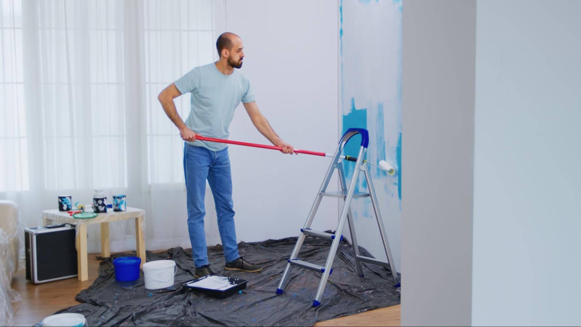 Interior commercial painting project in a multi-floor municipal facility with painters preparing office walls